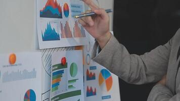 Business meeting time,business account managers crew working with new startup project,report analysis cost graph on desk at meeting room. video