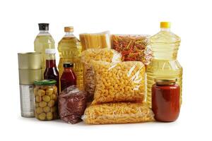 Foodstuffs in donation box isolated on white background with clipping path for volunteer to help people. photo