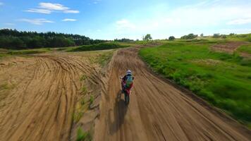 FPV drone chasing rider on a motocross track in slow motion. video