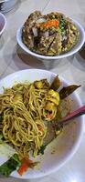 Giant Bakso, or Jumbo meatball is indonesian meatball style served with beef broth soup and noodle springkled with fried onion and spring onion coupled with chili sauce on the top photo