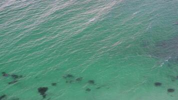 Aerial View of Turquoise Ocean Waters. A calm and serene, with the occasional ripple breaking the surface. video
