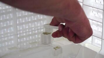 a close-up of a man's hands putting together parts of a beach sofa. Slow motion. assembly process of plastic beach furniture. video