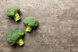 Top view fresh green broccoli vegetable on Colored background. Broccoli cabbage head Healthy or vegetarian food concept. Flat lay. Copy space photo