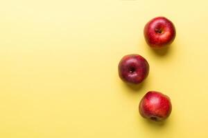 Many red apples on colored background, top view. Autumn pattern with fresh apple above view with copy space for design or text photo