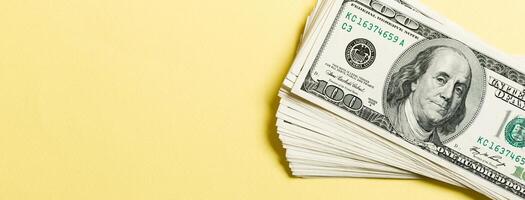 Top view of bundle of 100 dollar bill on colorful backgound. Business concept with copy space photo