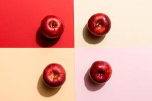 Many red apples on colored background, top view. Autumn pattern with fresh apple above view photo