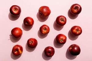Many red apples on colored background, top view. Autumn pattern with fresh apple above view photo