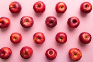 Many red apples on colored background, top view. Autumn pattern with fresh apple above view photo