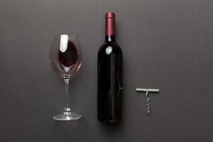 Flat lay composition with corkscrew, bottle of wine and elegant glass on colored table. Flat lay, top view wth copy space photo
