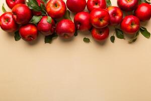 Many red apples on colored background, top view. Autumn pattern with fresh apple above view with copy space for design or text photo