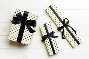 Top view of christmas or other holiday handmade present box package, flat lay white wooden background with copy space. new year gift box photo