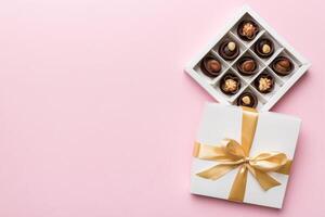 White box with chocolates candies and golden tape. top view with copy space photo