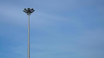 Spotlight pole on the side of the road The background is a blue sky photo