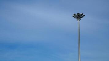 Spotlight pole on the side of the road The background is a blue sky photo