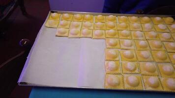 on the preparation of homemade ricotta and saffron ravioli, a traditional Italian dish. video