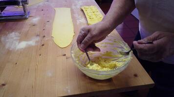 on the preparation of homemade ricotta and saffron ravioli, a traditional Italian dish. video