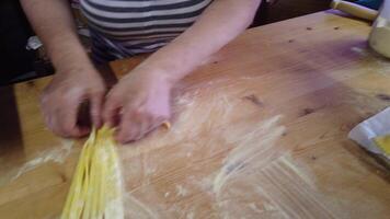 A person forms nests of handmade tagliatelle in the traditional way. video