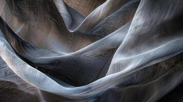 The sight of a flowing fabric revealing the drop of a cliff face photo