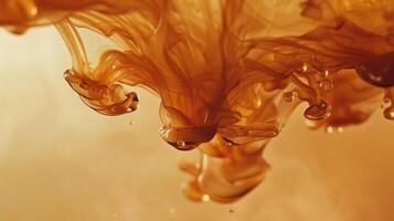 An ambercolored ink showcasing its thick consistency and depth of color as it drips from a pen nib onto a blank page photo