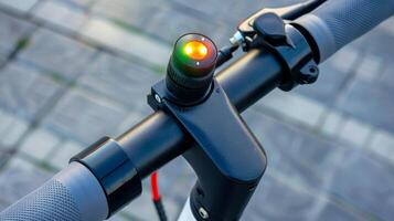 A detailed view of the bell on an electric scooters handlebar equipped with a brightly colored button for alerting pedestrians and other riders photo