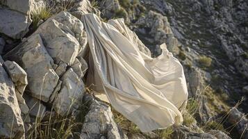 A toga fluttering against a rocky cliff as if trying to escape the grasp of the wearer and fly free in the wind photo
