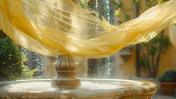 Pale yellow chiffon fabric delicately ds over the courtyard fountain adding a touch of elegance to the scene photo
