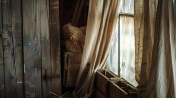 Through the fluttering curtains one can catch glimpses of the rusted farm tools and old wooden crates stored in the cozy barn photo