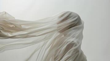 The soft and delicate fabric gently d over the subjects head creating a veillike effect in the studio photo
