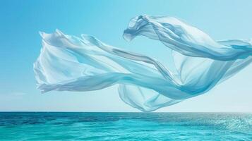 A light and airy cotton scarf gently moves above a serene ocean adding a touch of effortless elegance to the seascape photo
