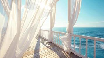 The sundeck of a seaside resort is dd with white curtains creating a dreamy atmosphere as they sway in the wind photo