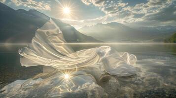 A romantic sight of gossamer fabric floating gracefully over a reflective lake creating a stunning panorama photo