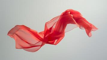 A bright red piece of fabric suspended from the ceiling appearing to float in midair as it is caught in the current of air photo