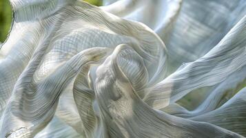 In the sculptors garden the fabric is a symbol of the fleeting nature of art constantly in motion and changing with the wind photo