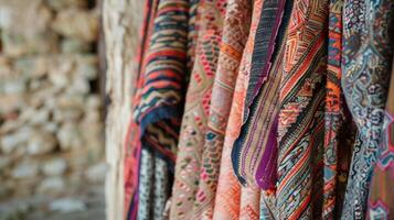 A mix of patterned fabric pieces blowing in the wind on a rustic stone terrace creating a bohemian vibe photo