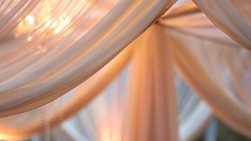 A delicate tapestry of fabric ds from the center of the pavilion adding an elegant touch photo