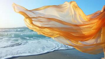 A deserted beach is brought to life by a vibrant shawl billowing in the strong ocean breeze photo