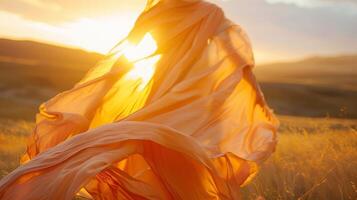 A dazzling sunset illuminating a figure dd in a gauzy poncho the fabric billowing in the gentle evening breeze photo