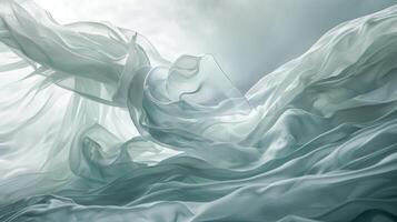 An almost translucent sheet of cloth waves and dips mimicking the fluid movements of a trained dancer photo