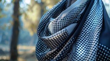 A classic black and white foulard scarf flutters gracefully adding a hint of sophistication to a casual ensemble photo