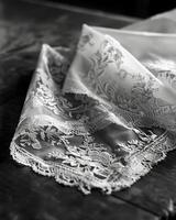 A handkerchief with delicate lace trim is carefully folded a reminder of the elegant accessories once commonplace in fashion. Black and white art. photo