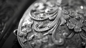 The small details of a vintage brooch from the intricate etching to the fading sheenart.e highlighted in a black and white photo. Black and white art. photo