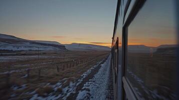 As dusk settles in the train continues on its journey offering a frontrow view of the sunset photo