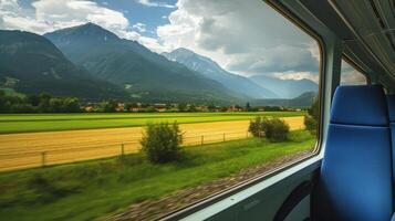 Rolling farmland gives way to towering mountains in the distance photo