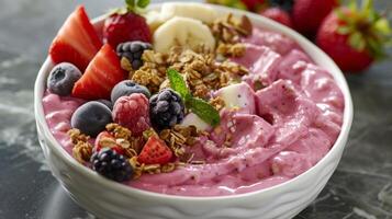 A smoothie bowl topped with granola and a vibrant display of colorful fruits all enhanced with a hint of avocado oil photo