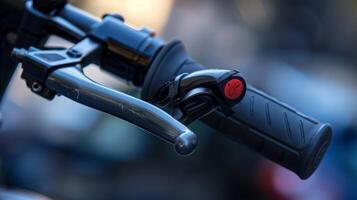 Closeup of an escooters brake lever with its smooth metallic finish and small red button for engaging the brake system photo