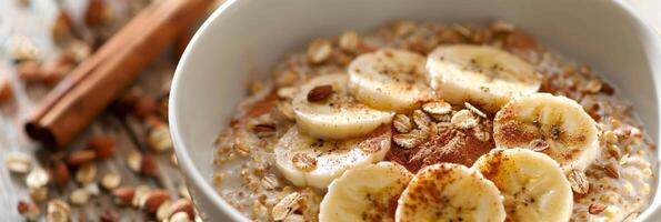 A nourishing breakfast choice of buckwheat cereal topped with sliced banana a sprinkle of cinnamon and a splash of coconut milk photo