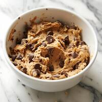 A bowl filled with buckwheat cookie dough beckoning to be tasted before baking photo