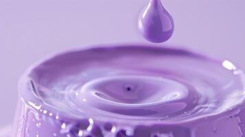 A soft lavender ink captured in a round droplet suspended on the edge of its container highlighting its unique hue photo