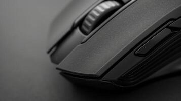 A closeup of a matte black wireless mouse highlighting its ergonomic design for comfortable use photo