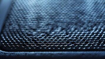 A detailed closeup of a portable SSD captures the fine details of its textured surface providing a secure grip for handling photo